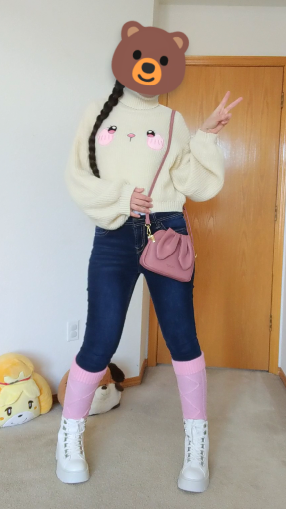 Girl wearing a kawaii sweater with jeans, a purse, and pink socks.